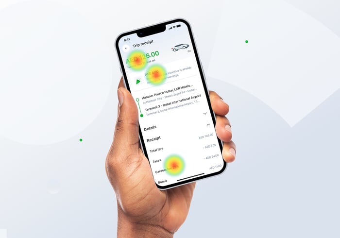 A hand holding Careem app with receipt screen