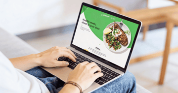 Powemeals website on a laptop.